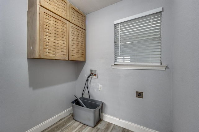 laundry area with cabinets, washer hookup, hookup for an electric dryer, and light wood-type flooring