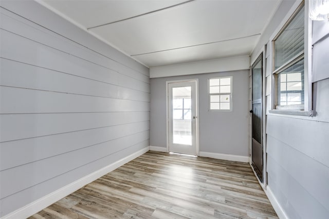 doorway to outside featuring plenty of natural light and light hardwood / wood-style floors