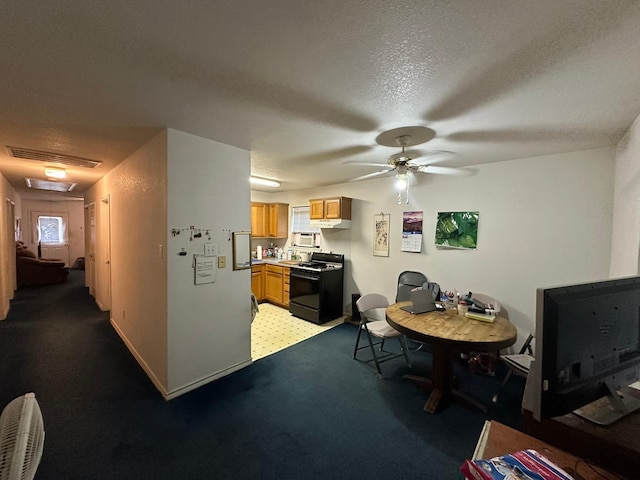 carpeted dining room with ceiling fan and a textured ceiling