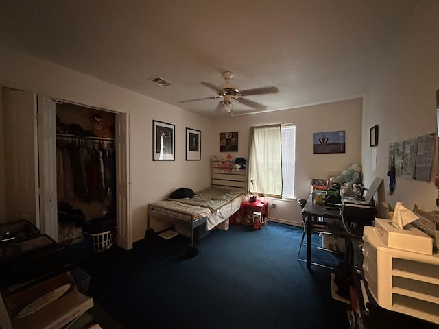 carpeted bedroom featuring ceiling fan and a closet