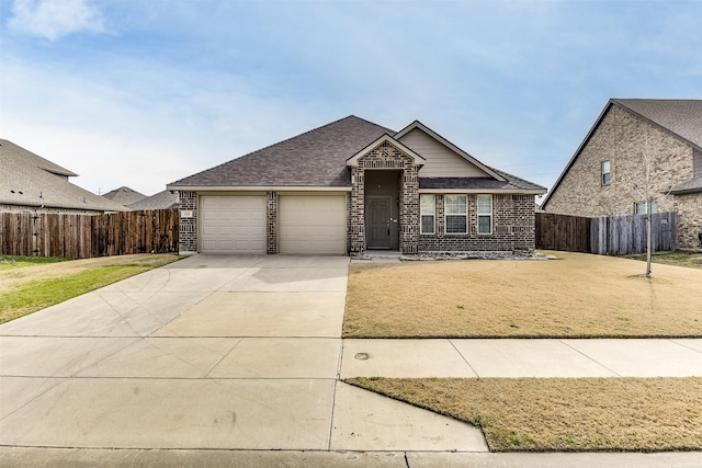 view of front of home with a garage and a front lawn