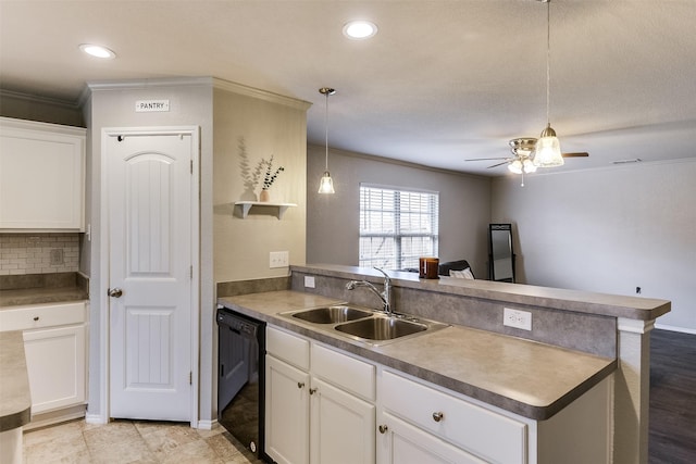 kitchen with sink, white cabinetry, hanging light fixtures, black dishwasher, and kitchen peninsula