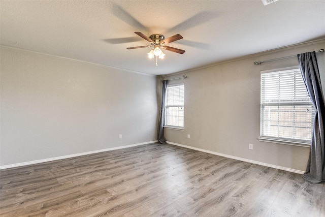 spare room with hardwood / wood-style flooring, ornamental molding, ceiling fan, and a textured ceiling