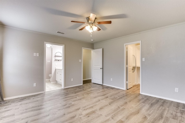 unfurnished bedroom featuring ornamental molding, connected bathroom, and light hardwood / wood-style flooring