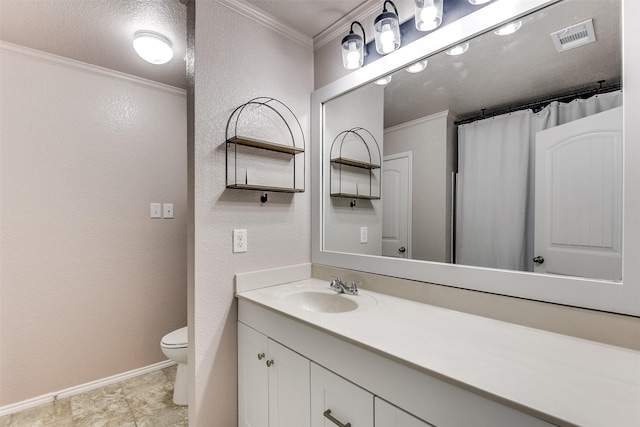 bathroom featuring crown molding, vanity, a textured ceiling, and toilet