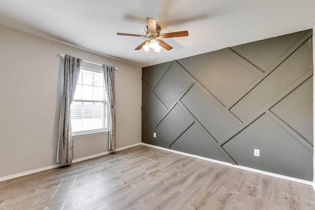 unfurnished room with light hardwood / wood-style flooring and ceiling fan