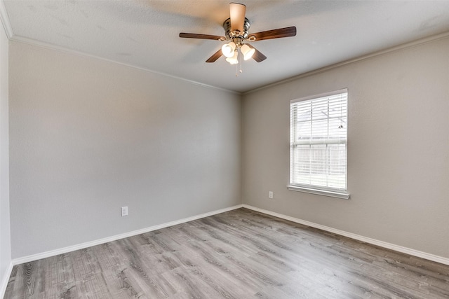 spare room featuring ceiling fan, ornamental molding, and light hardwood / wood-style floors