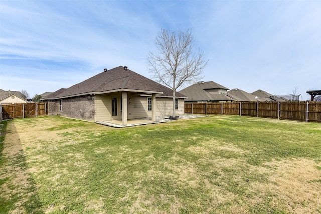 rear view of property featuring a patio and a yard