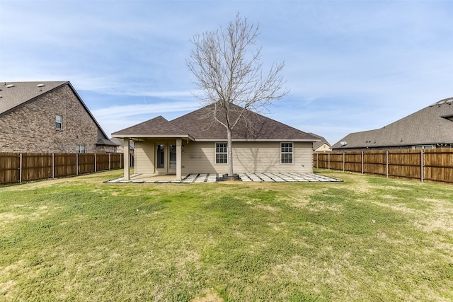 rear view of house with a patio area and a lawn