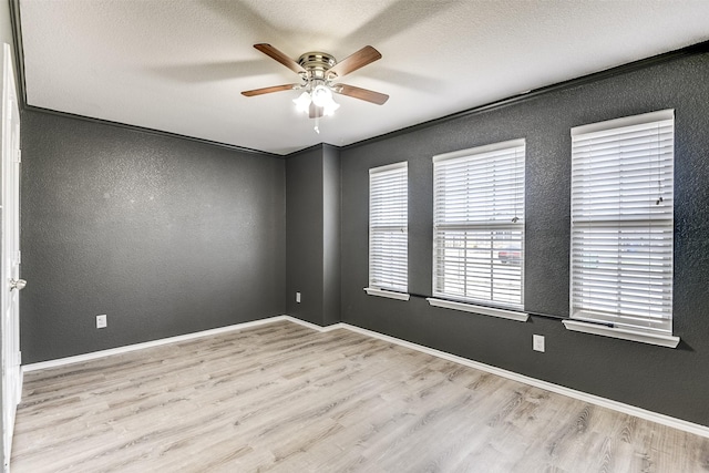 empty room featuring ceiling fan, a textured ceiling, and light hardwood / wood-style floors