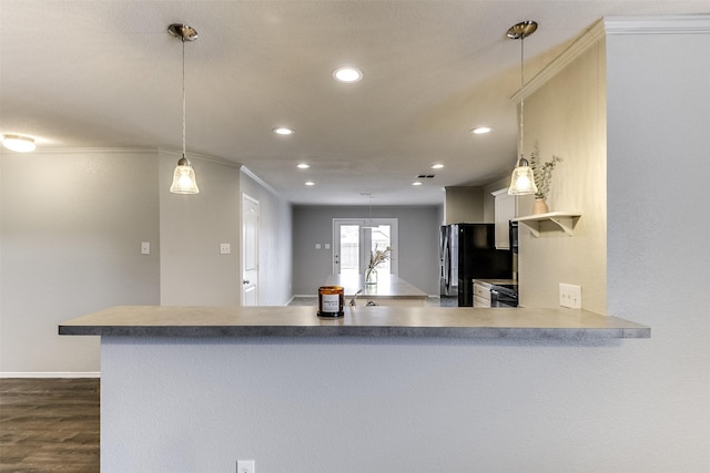 kitchen with black refrigerator, pendant lighting, dark hardwood / wood-style floors, ornamental molding, and kitchen peninsula