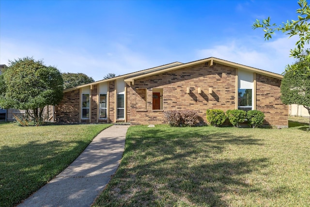 ranch-style home with a front lawn