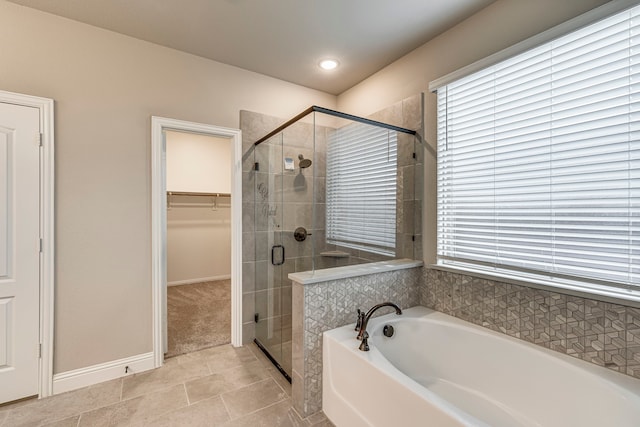 bathroom with separate shower and tub and tile patterned flooring