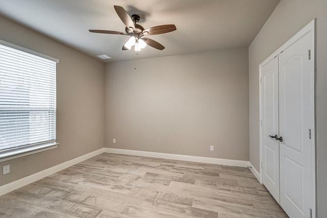 unfurnished bedroom featuring a closet, ceiling fan, and light hardwood / wood-style flooring