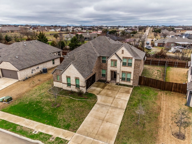 view of front of house featuring a garage and a front lawn