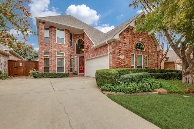 view of front of property with a garage and a front lawn