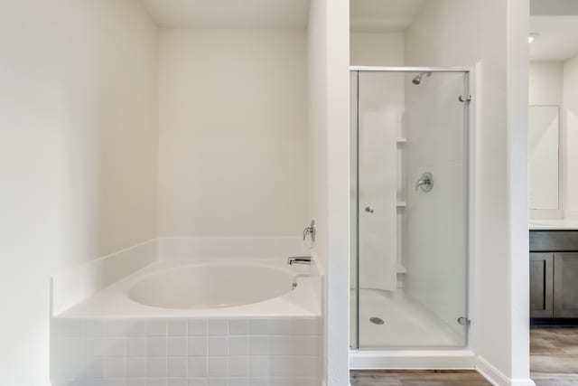 bathroom featuring vanity, hardwood / wood-style flooring, and separate shower and tub