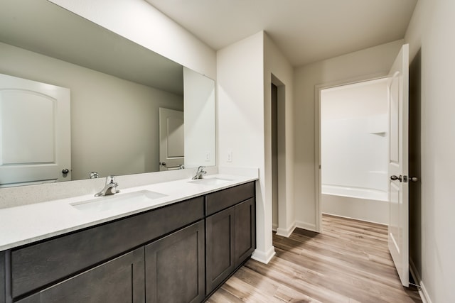 bathroom with hardwood / wood-style flooring and vanity