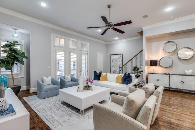 living room featuring crown molding, dark wood-type flooring, and ceiling fan