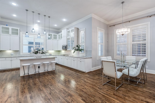 kitchen with a kitchen breakfast bar, white cabinets, and a kitchen island