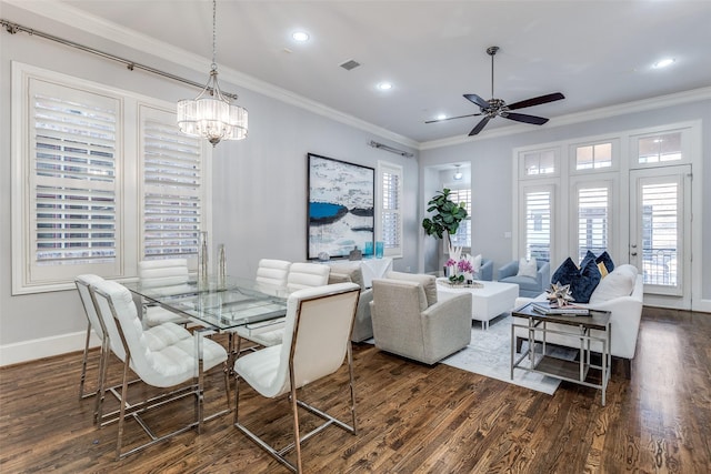 dining room featuring ceiling fan with notable chandelier, ornamental molding, and dark hardwood / wood-style floors