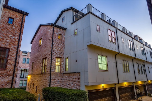 outdoor building at dusk featuring a garage