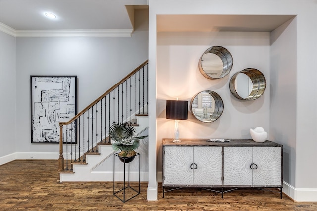 stairway with crown molding and wood-type flooring