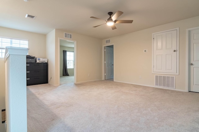 unfurnished bedroom with light colored carpet and ceiling fan