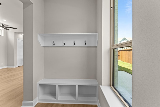 mudroom with baseboards, a ceiling fan, and wood finished floors
