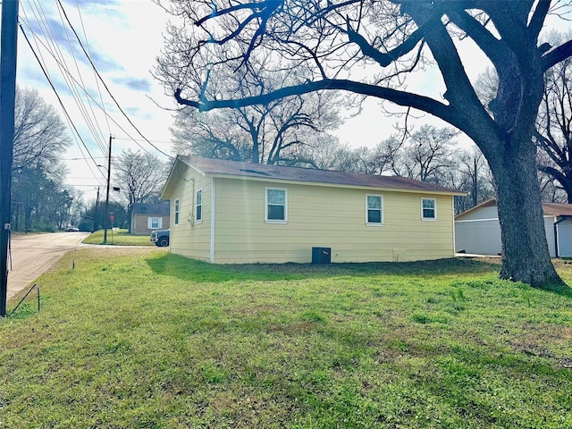 view of home's exterior with a yard and central air condition unit