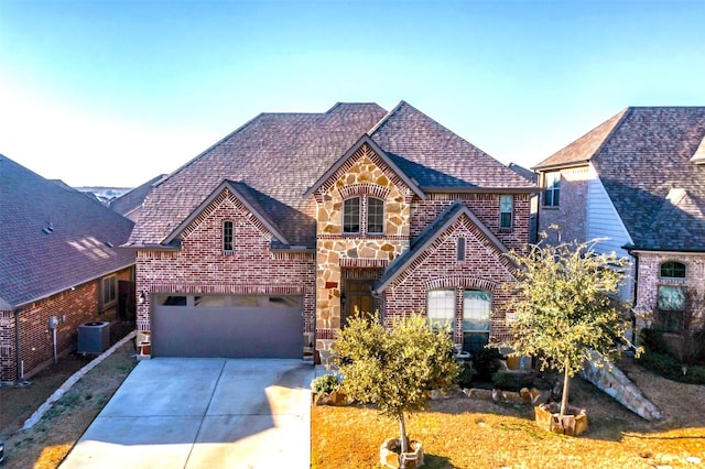 view of front of home with cooling unit and a garage