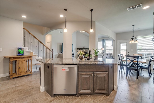 kitchen featuring sink, decorative light fixtures, light hardwood / wood-style flooring, dishwasher, and a wealth of natural light