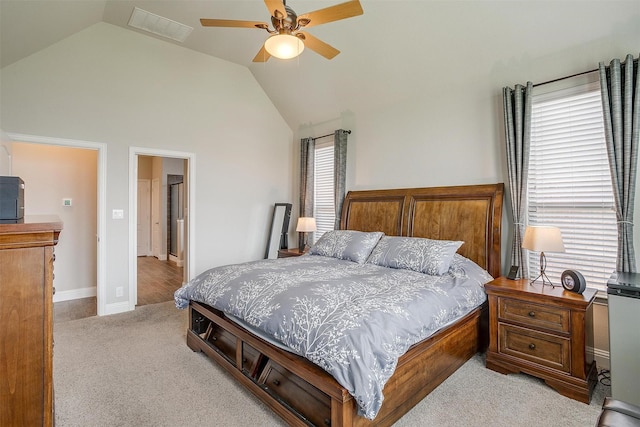 carpeted bedroom with ceiling fan and lofted ceiling