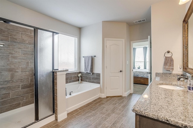 bathroom featuring vanity and shower with separate bathtub