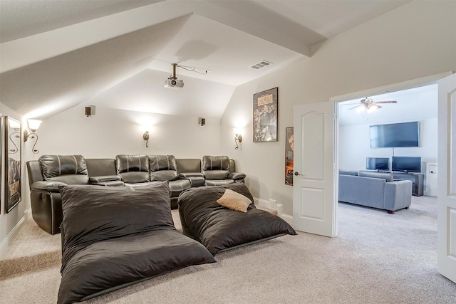 cinema room featuring vaulted ceiling and light carpet