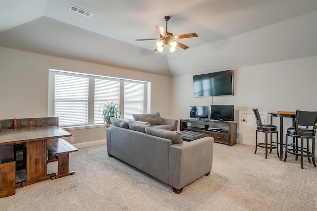 living room with ceiling fan, light colored carpet, and lofted ceiling