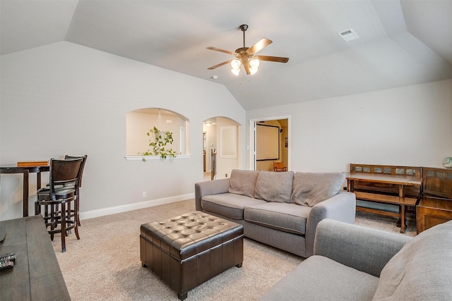 living room with vaulted ceiling, light colored carpet, and ceiling fan