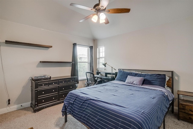 carpeted bedroom with vaulted ceiling and ceiling fan