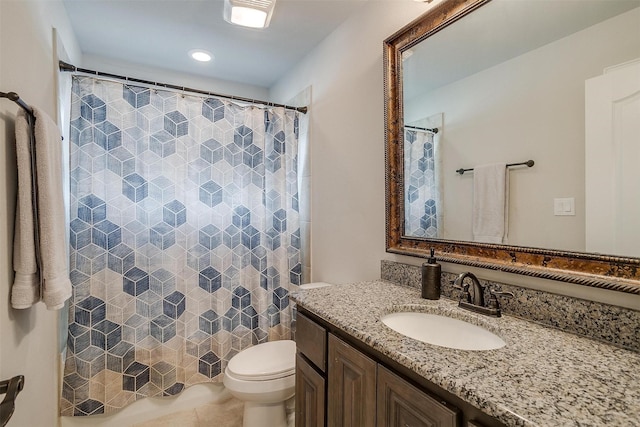 bathroom featuring vanity, toilet, and tile patterned flooring