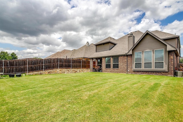 exterior space with a yard and central AC unit