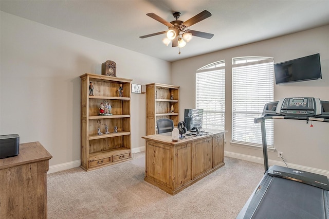 carpeted office space with ceiling fan