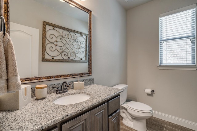 bathroom featuring vanity and toilet