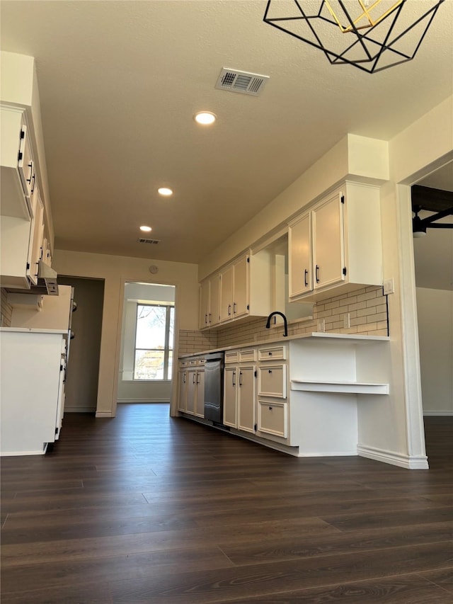 kitchen with black dishwasher, visible vents, backsplash, and white cabinetry