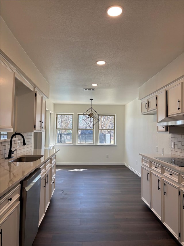 kitchen featuring dishwasher, black electric stovetop, a sink, and white cabinets