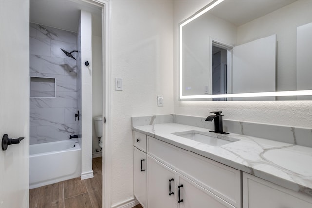 full bathroom featuring baseboards, a textured wall, bathing tub / shower combination, wood tiled floor, and vanity