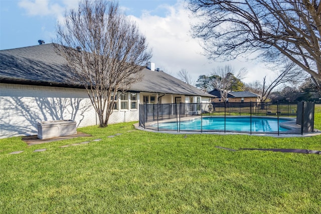 view of swimming pool featuring fence, a fenced in pool, and a yard