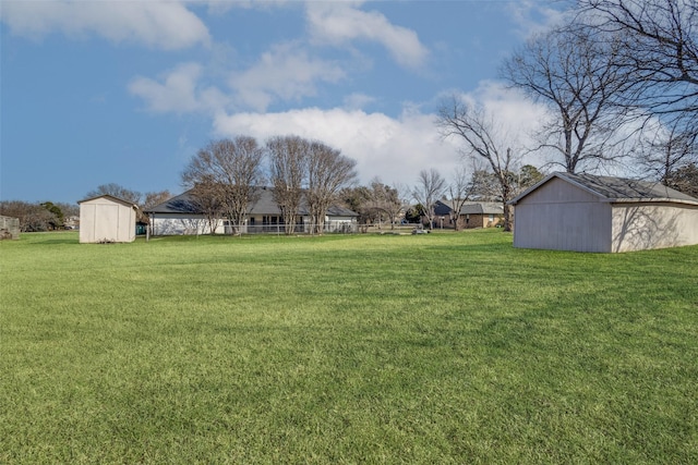 view of yard with an outbuilding and a shed