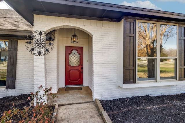 doorway to property with brick siding