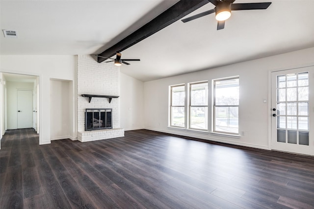 unfurnished living room with vaulted ceiling with beams, visible vents, dark wood-type flooring, a brick fireplace, and ceiling fan