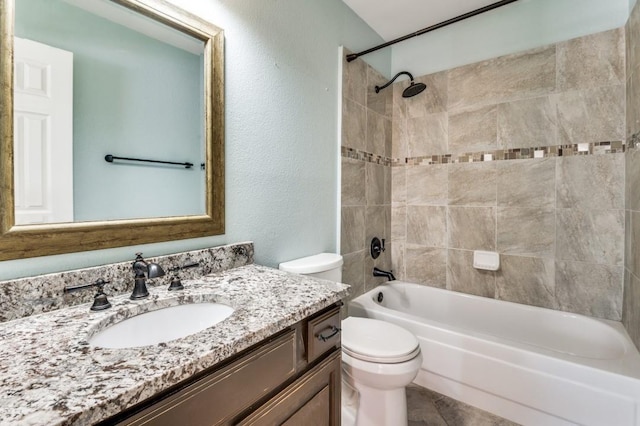 bathroom with  shower combination, a textured wall, toilet, and vanity